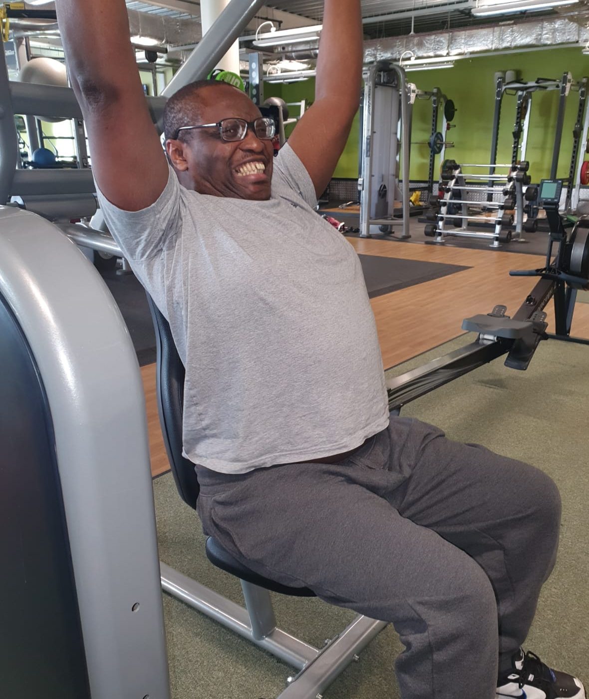 Stephen lifting weights at the gym