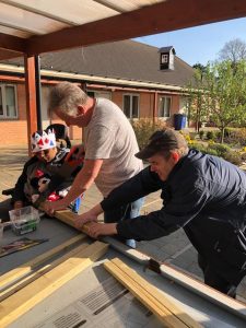 Residents cutting wood for the workshop project