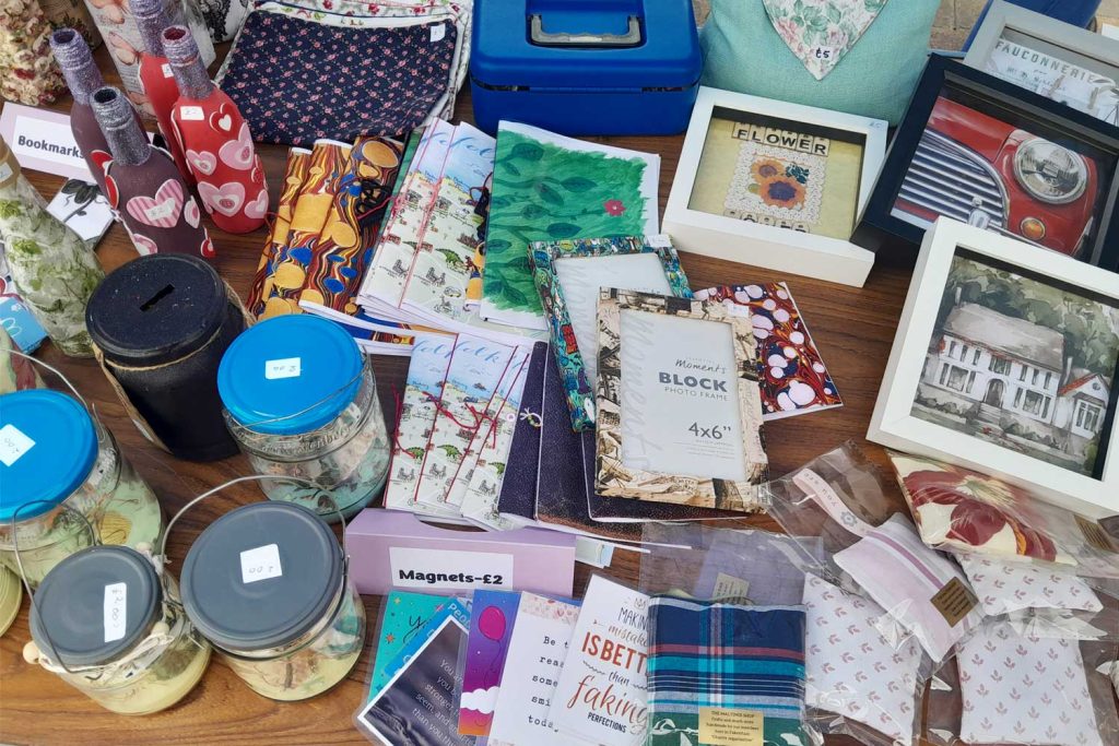 Selection of charity merchandise for sale on a market stall