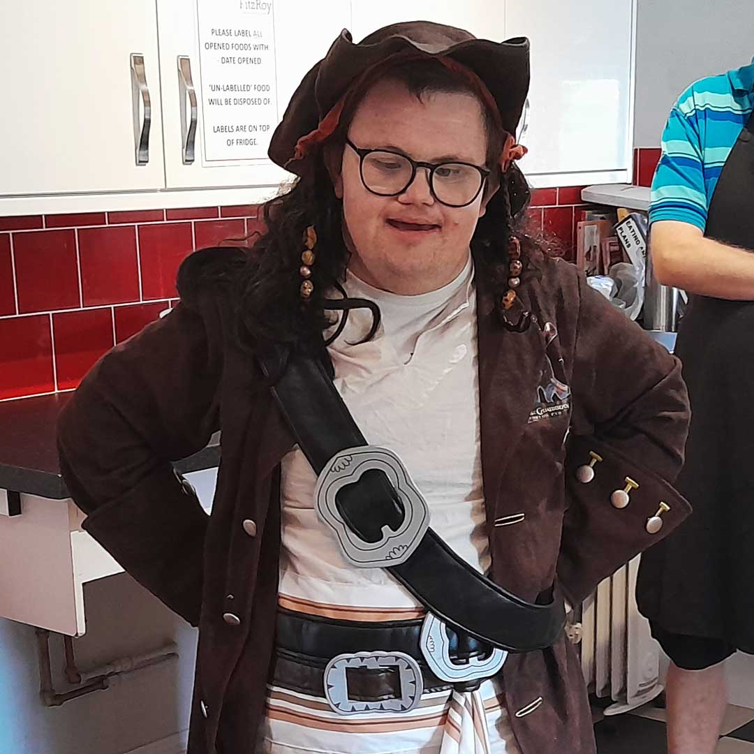 Young man stood in a kitchen dressed up as a pirate