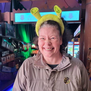 Woman in grey jacket wearing a Shrek headband