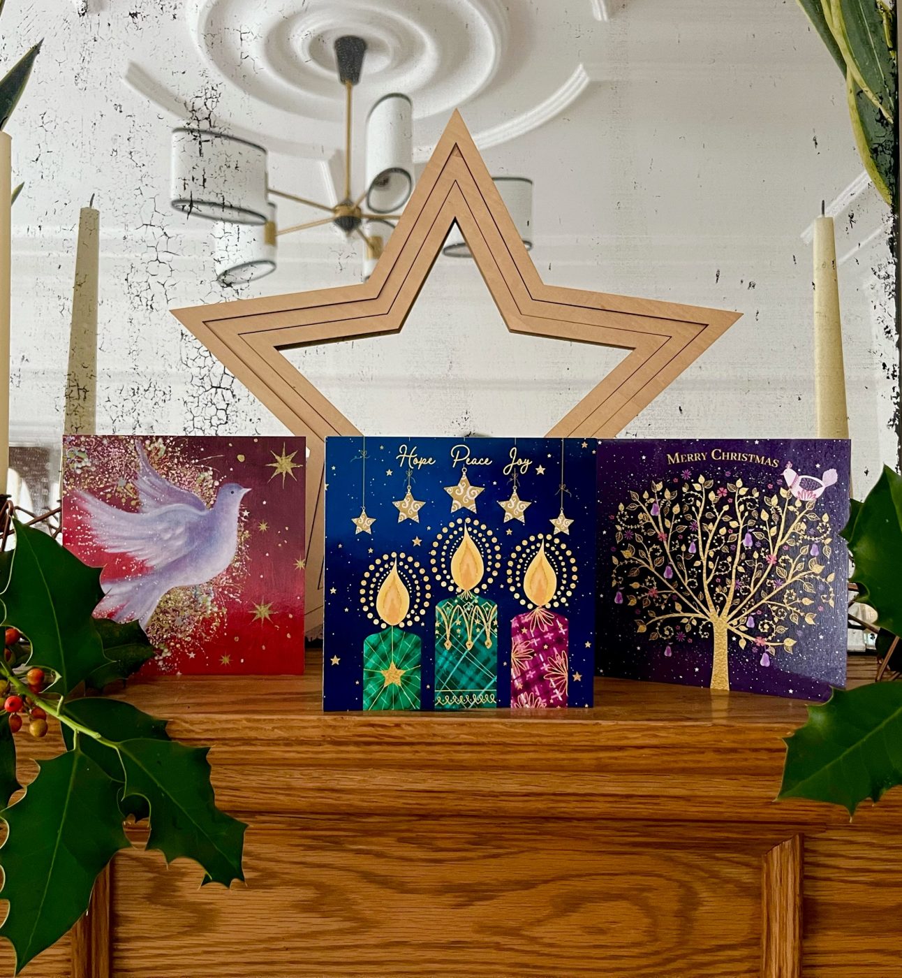 3 christmas cards on a mantel