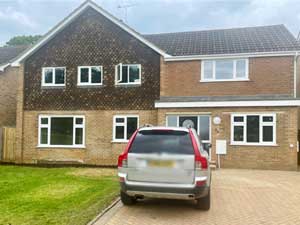 Detached house with a silver Volvo parked in front of it