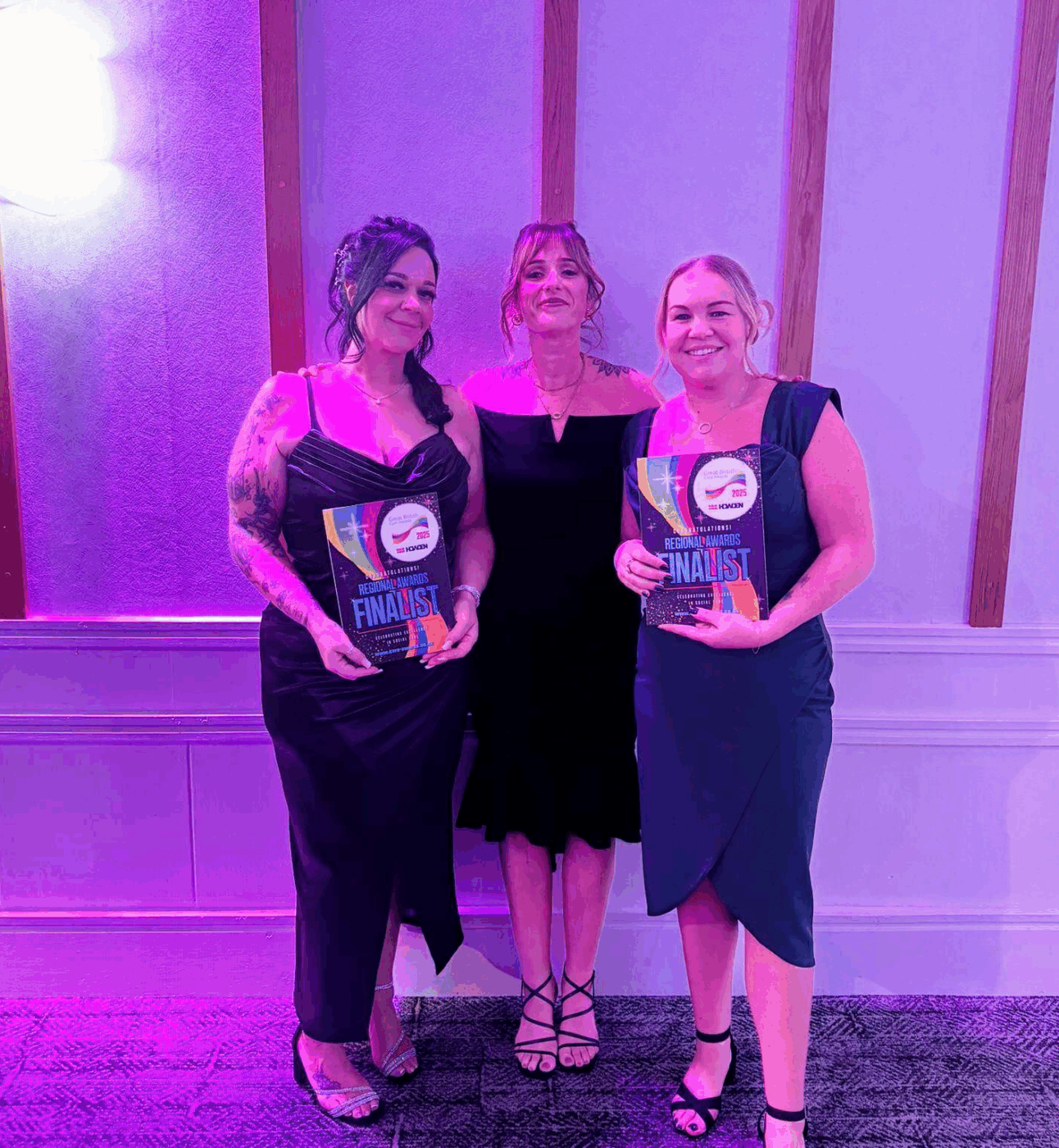 Finalists Jess and Marie are holding their certificates and standing with their regional manager Kimberley