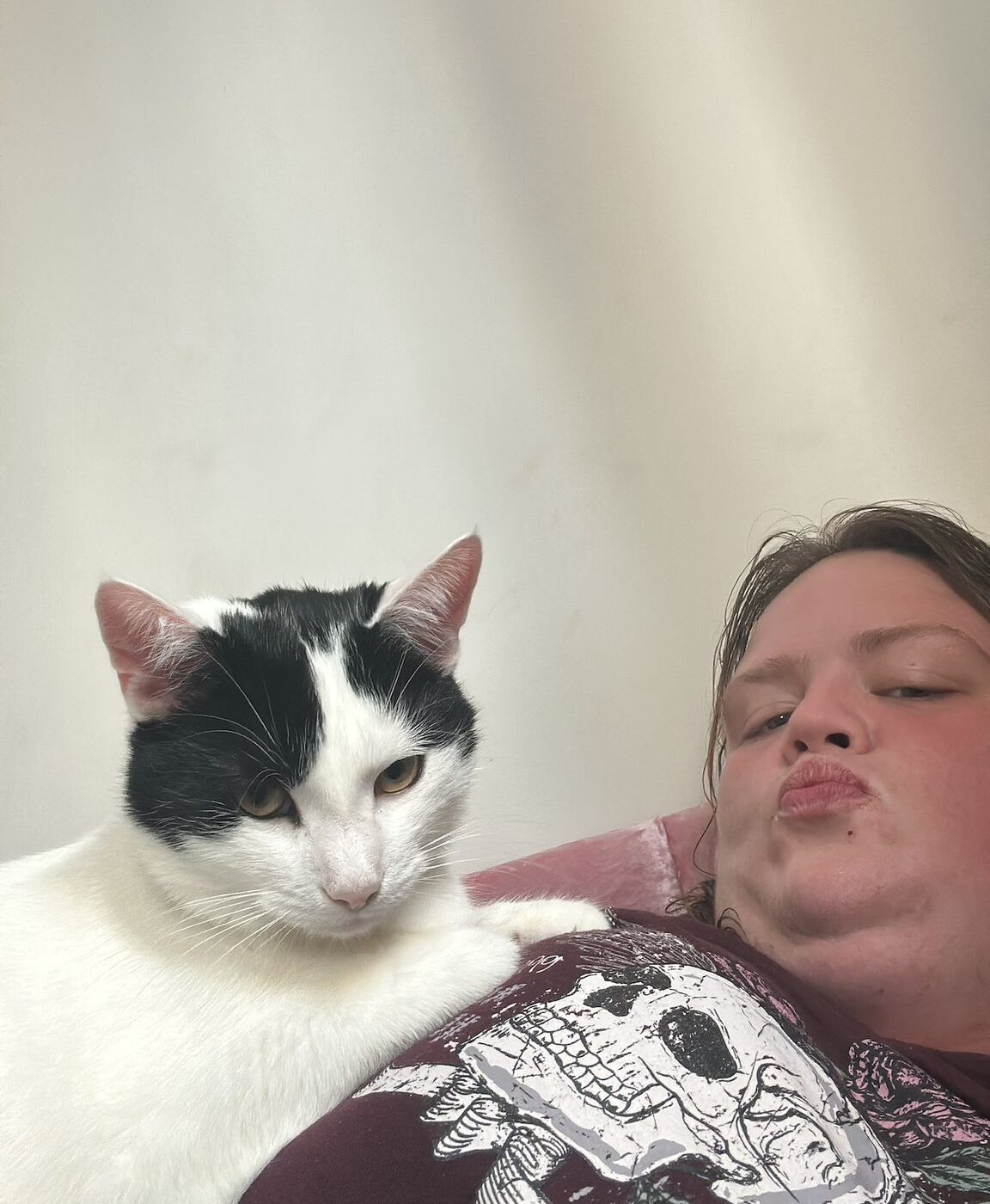 Sarah relaxing with her black and white cat Ross