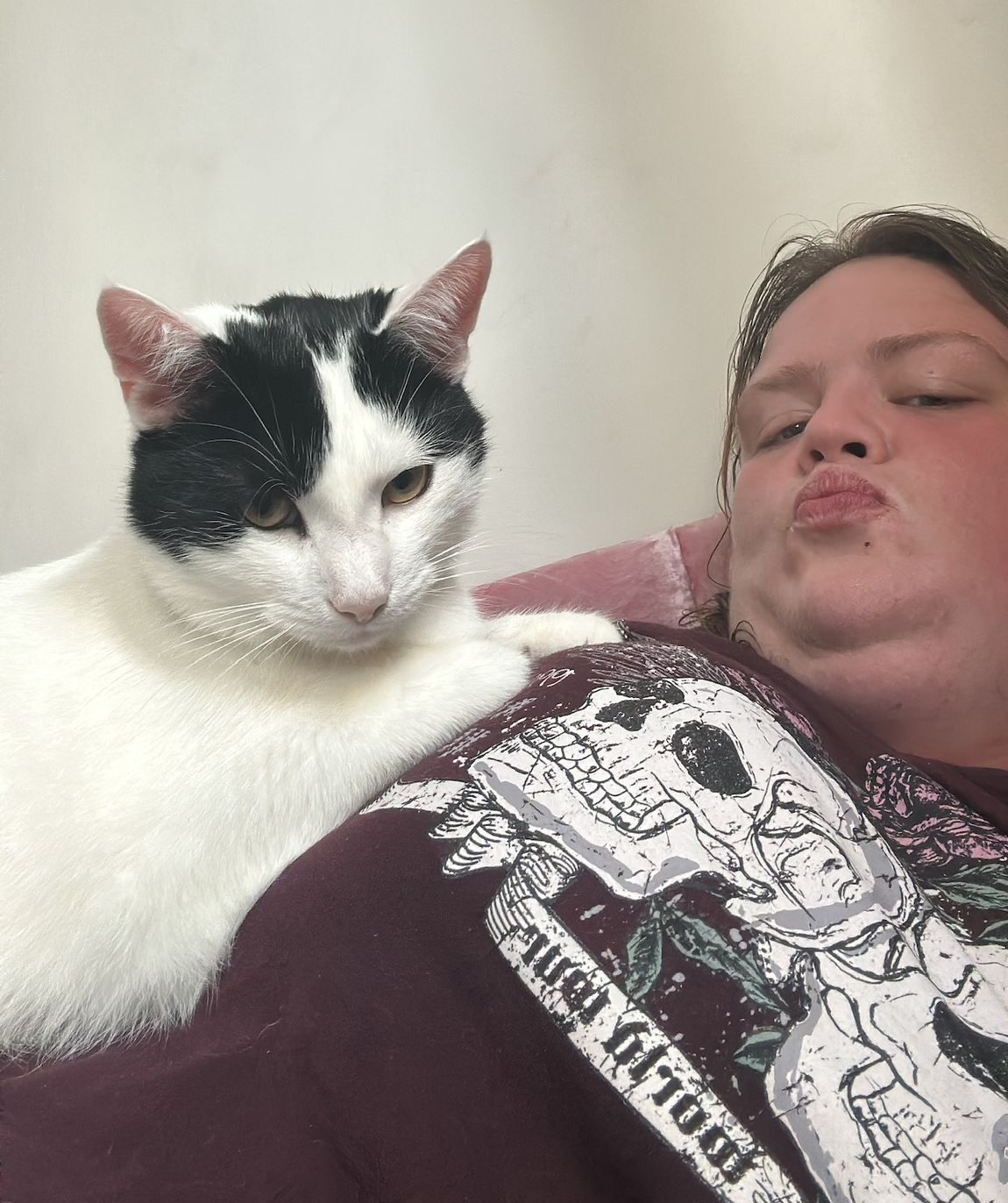 Sarah relaxing with her black and white cat Ross
