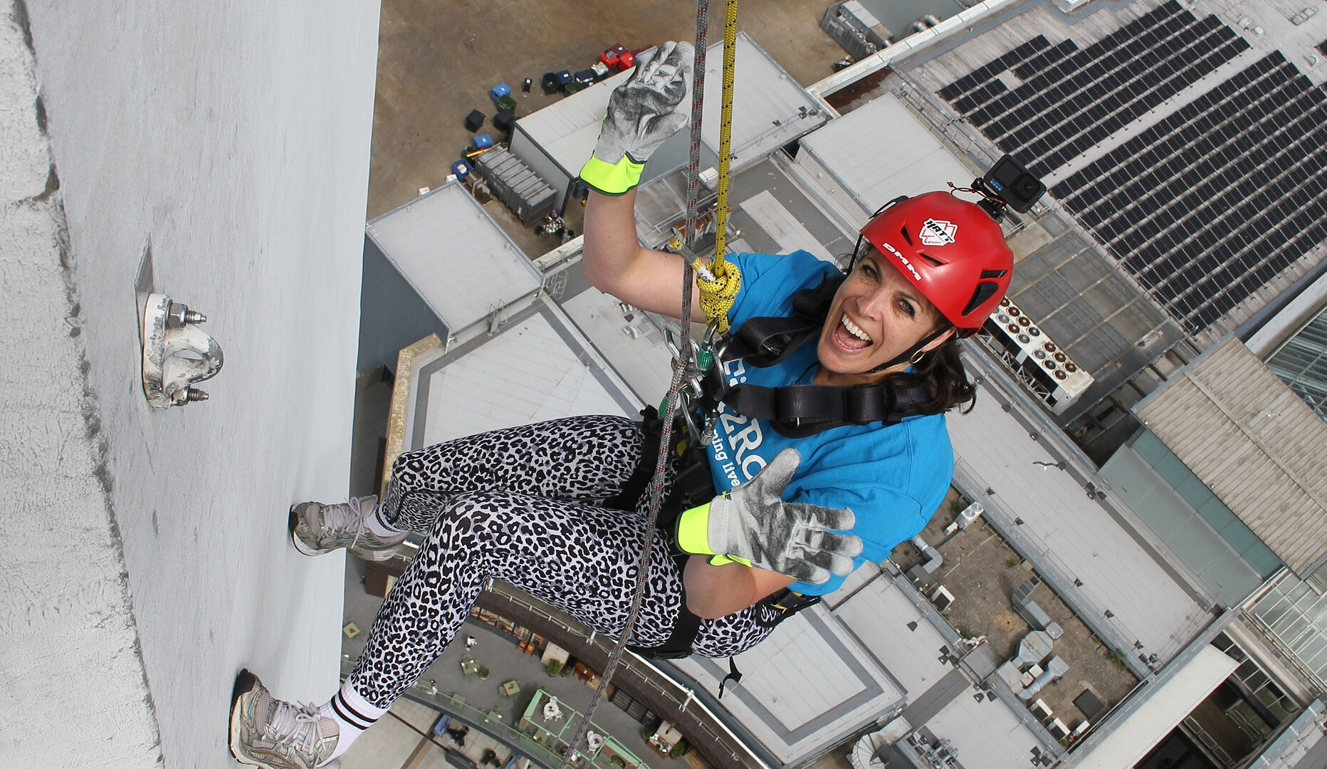 Zoe smiles as she abseils down Portsmouth’s Spinnaker Tower, still high above the ground during a FitzRoy fundraising challenge.